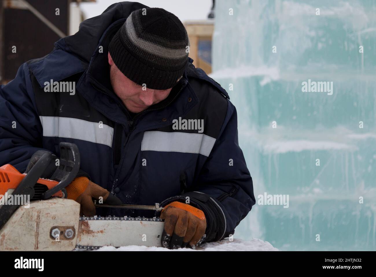 A manual file worker sharpens a chainsaw chain Stock Photo