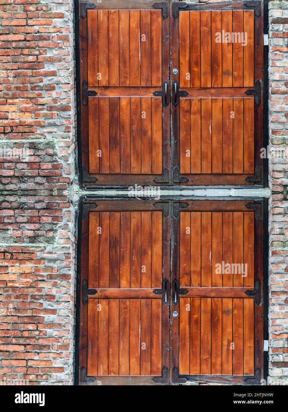 Red painted wooden barn door and window in old brick wall Stock Photo ...