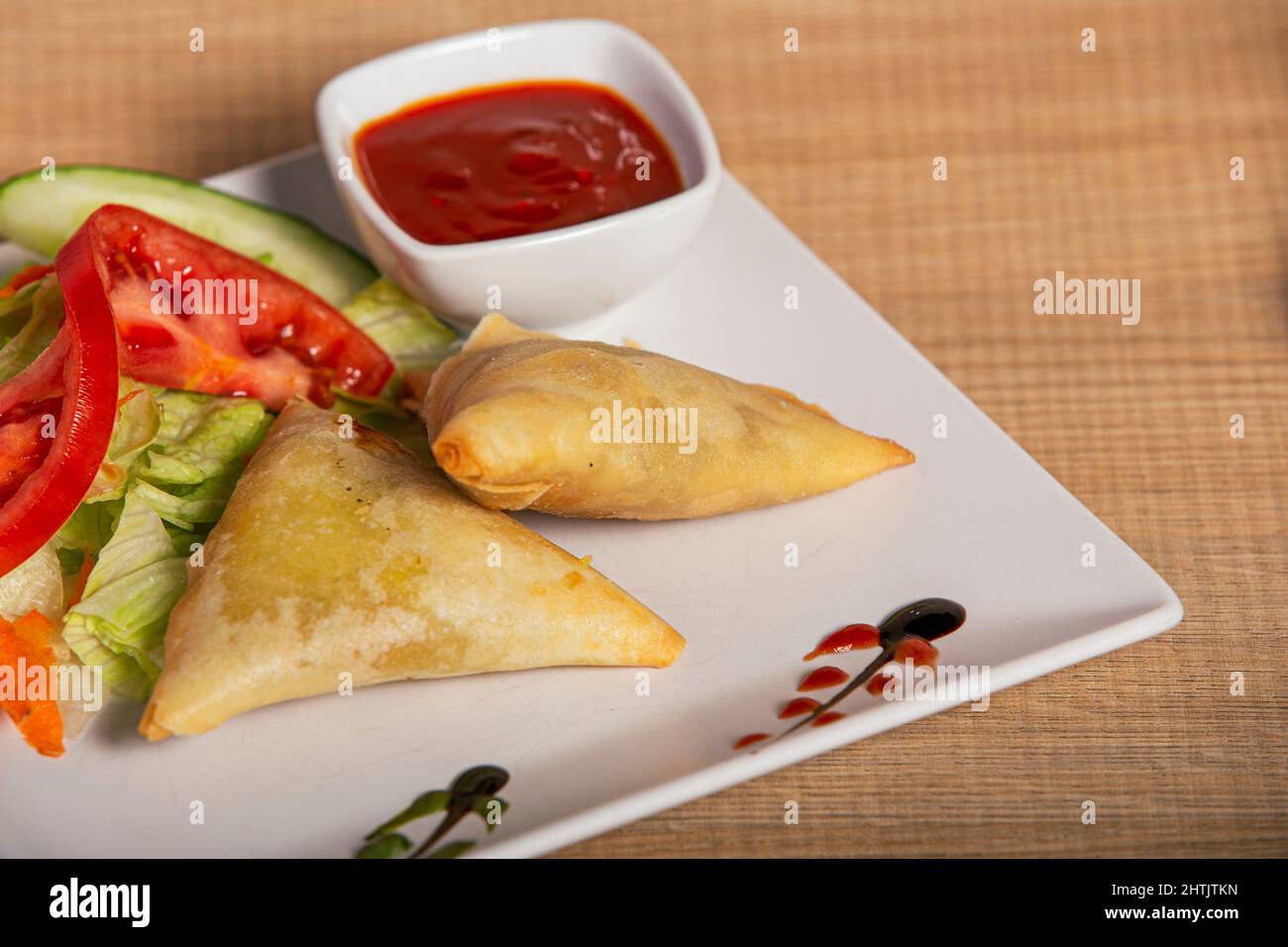 vegetable samosa served with sauces Ramadan Indian food, Pakistani food