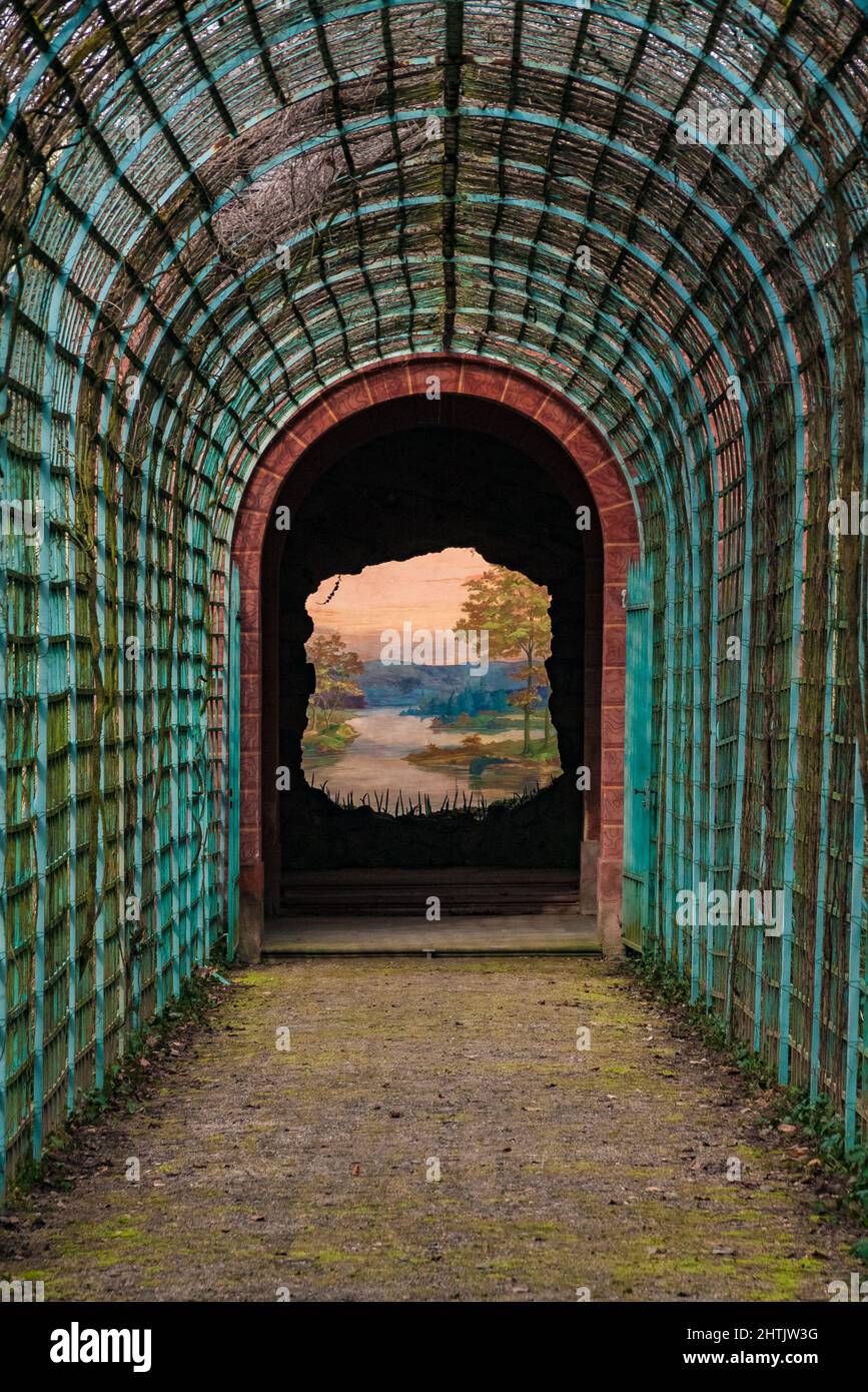 A wall with a painting called 'The Perspective' or 'End of the world' in the Bath House garden of castle Schwetzingen in Germany. A river landscape... Stock Photo