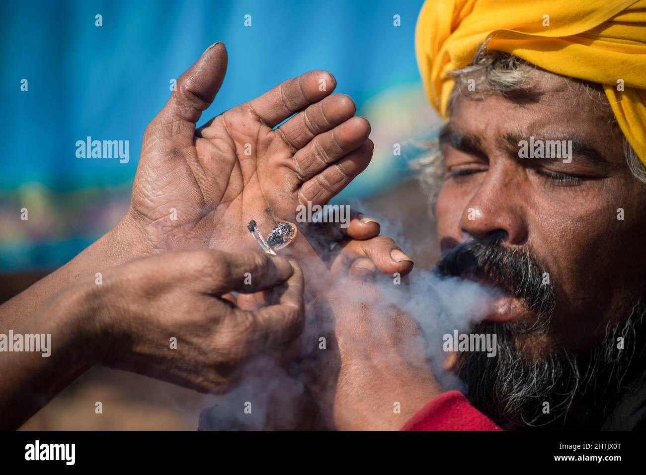 Kathmandu, Nepal. 01st Mar, 2022. A Sadhu or holy man smokes marijuana using a chillum (traditional clay pipe) as a holy offering during the festival at premises of Pasupatinath Temple. Maha Shivaratri is one of the biggest Hindu festivals celebrated annually in honor of Lord Shiva and in particular, marks the night when Shiva performs the heavenly dance. Credit: SOPA Images Limited/Alamy Live News Stock Photo