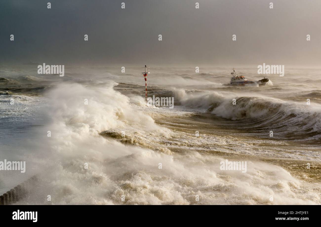A lifeboat braving the waves at the harbor head of the port of Vlissingen during powerful storm Eunice on Feb. 18. 2022 Stock Photo