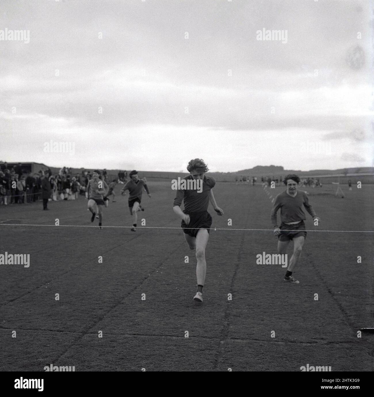 1960s, historical, school athletics, outdoors on a grass field in a