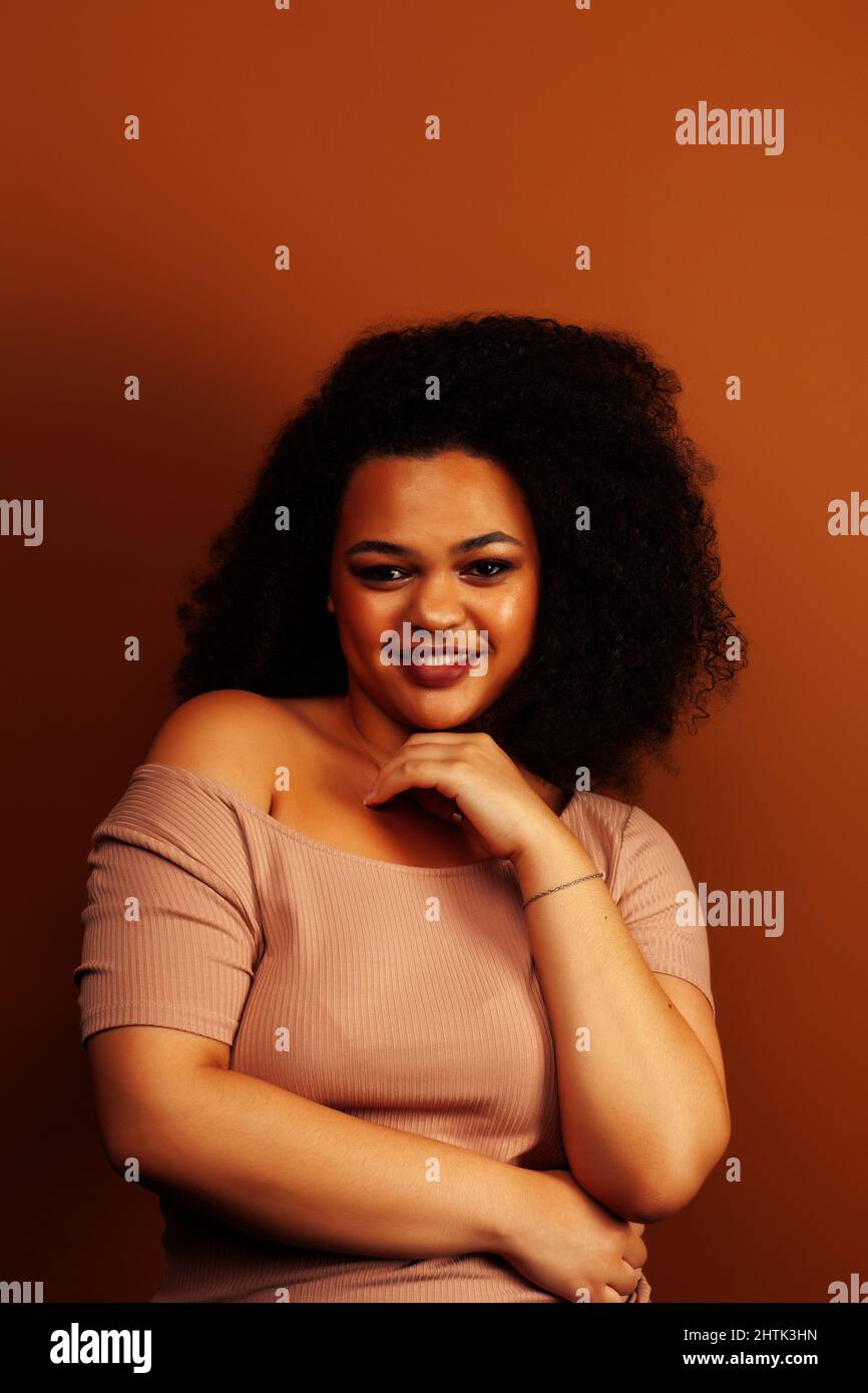 pretty young african american woman with curly hair posing cheerful ...