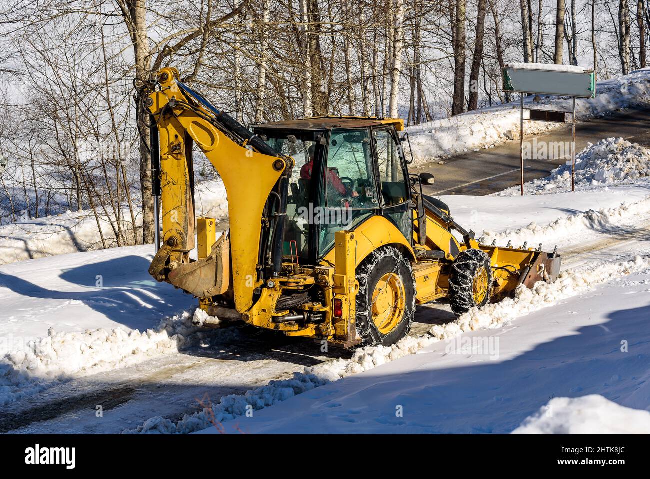 Snow removal works, snow removal machine in action on a cold winter day
