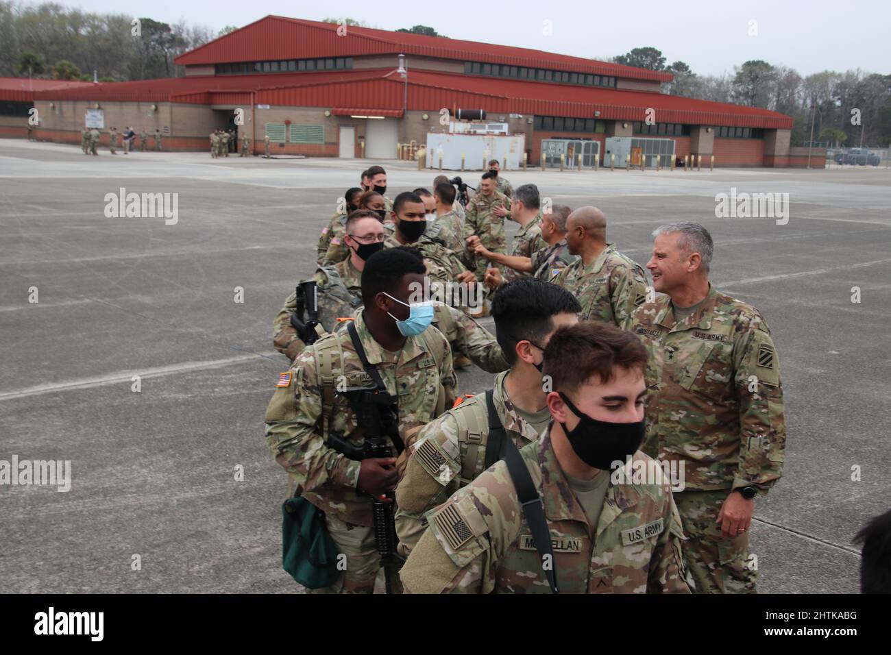 Savannah, United States. 27th Feb, 2022. U.S. Army soldiers, assigned to the 1st Armored Brigade Combat Team, 3rd Infantry Division, are fist bumped by commanding officers as they board a civilian aircraft for deployment to NATO countries from Hunter Army Airfield, February 27, 2022 in Savannah, Georgia. The soldiers are deploying to Eastern Europe in support of NATO allies and deter Russian aggression toward Ukraine. Credit: Capt. John D. Howard Jr/U.S Army/Alamy Live News Stock Photo