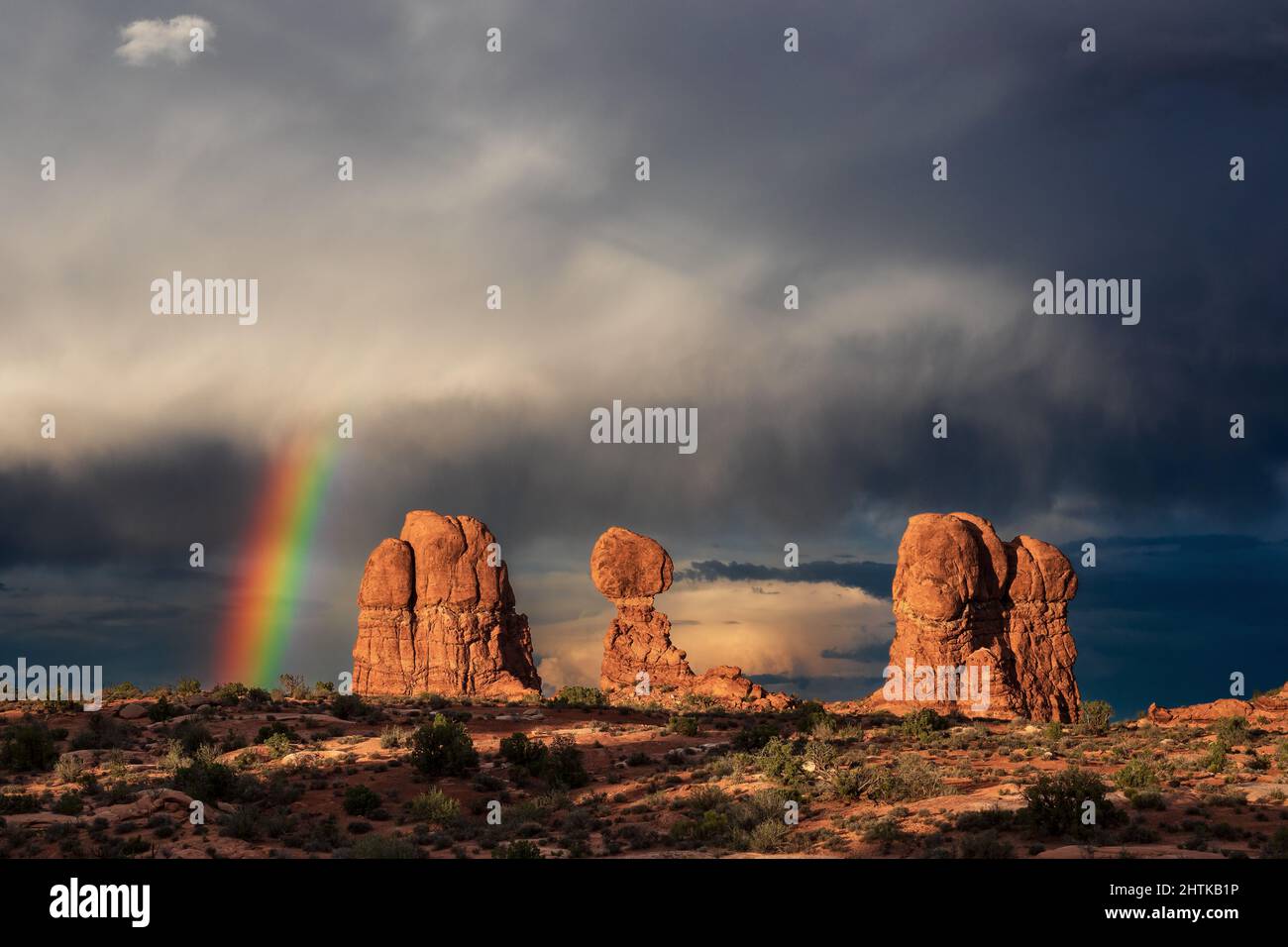 Balanced Rock in Arches National Park, Utah with a rainbow and storm Stock Photo