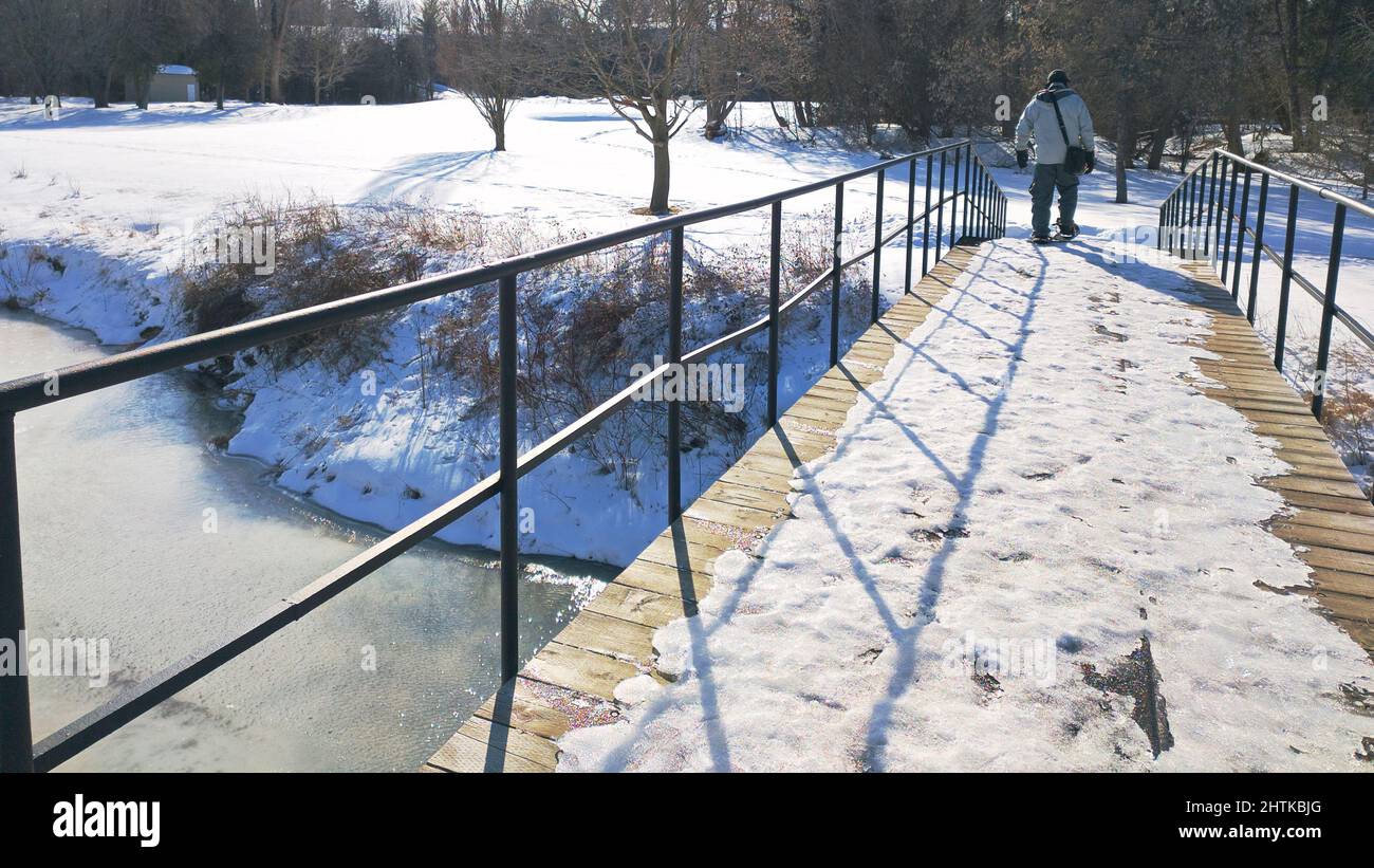 Diminishing perspective view of walking over the bridge in winter. Stock Photo