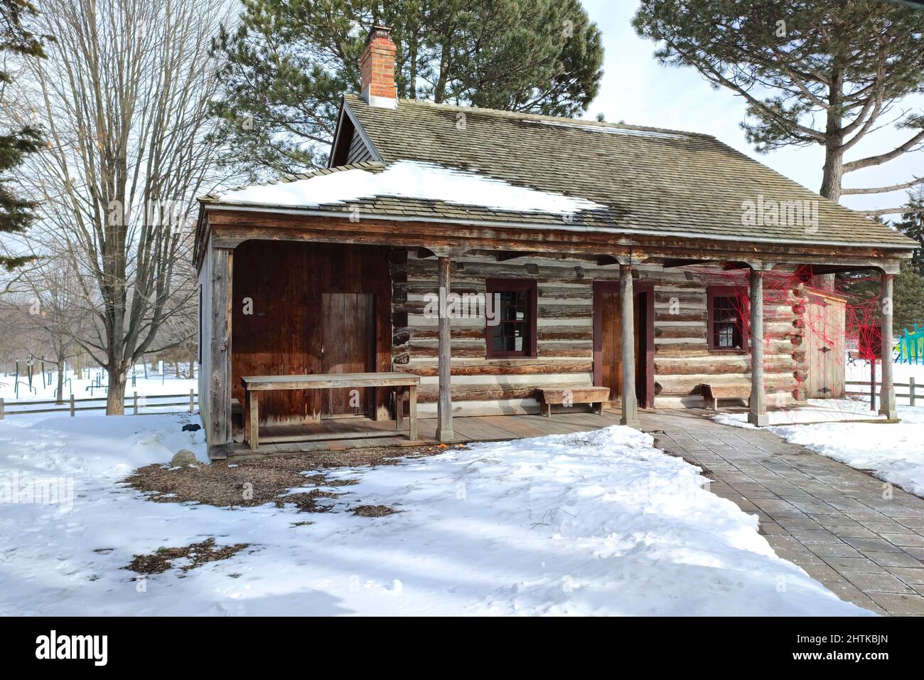 Snowy log cabin in the public park. Stock Photo