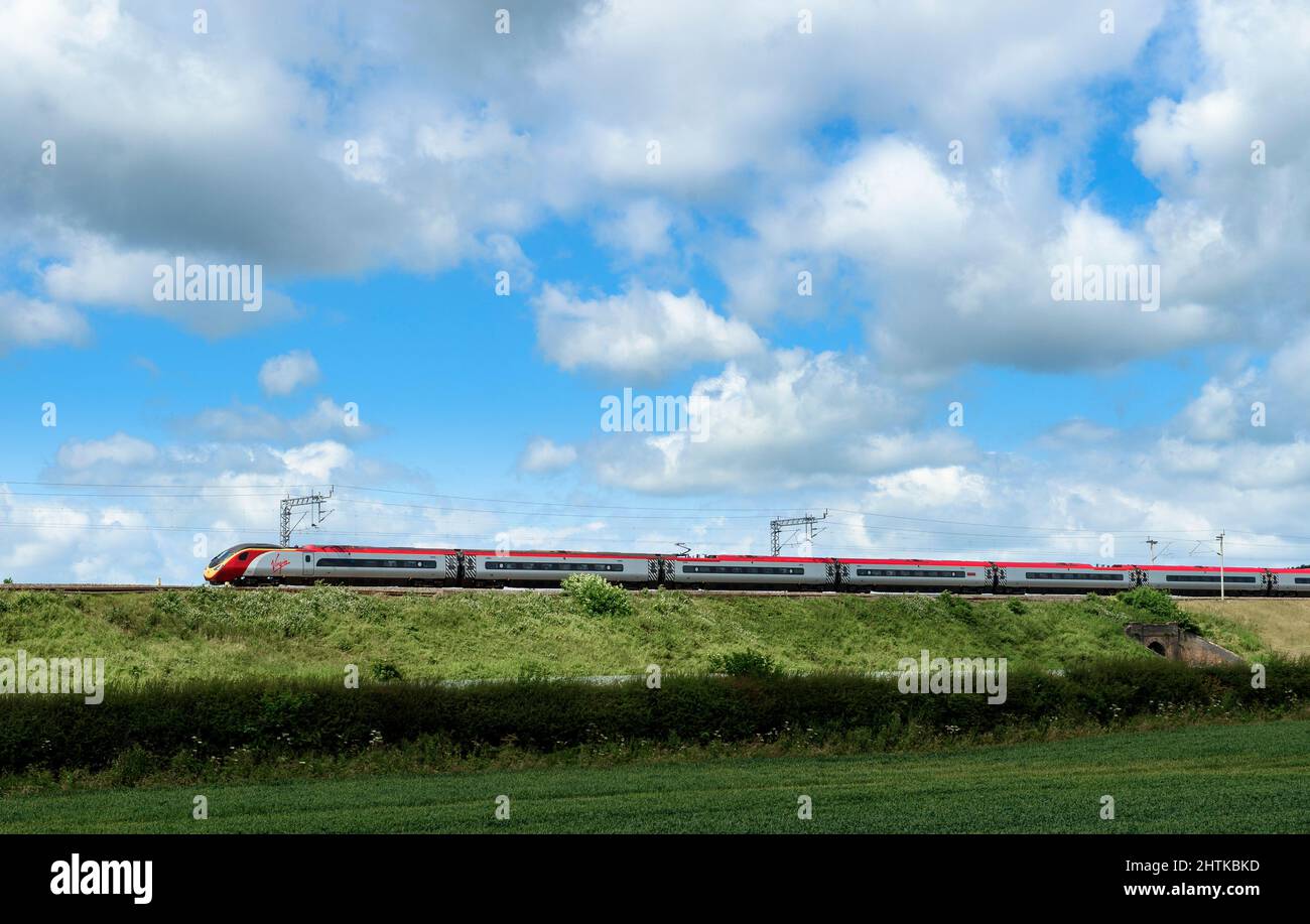 Virgin trains pendolino train speeding along the West Coast Main Line, England. Stock Photo