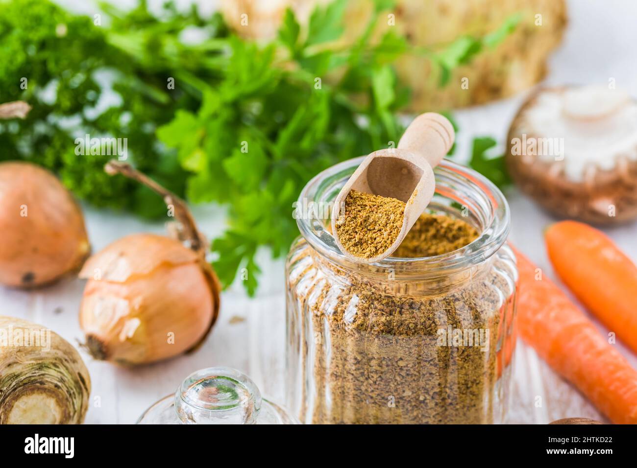 Homemade vegetable broth powder, organic vegetable stock, with raw vegetables on white wooden