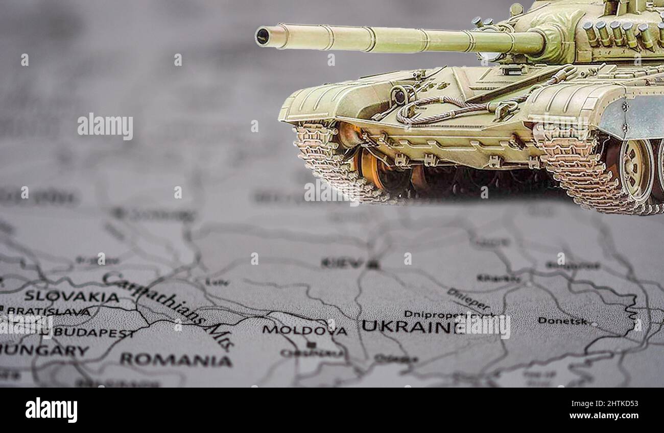 black and white geographic map of europe and ukraine and in the foreground an a colored model of a Russian tank Stock Photo