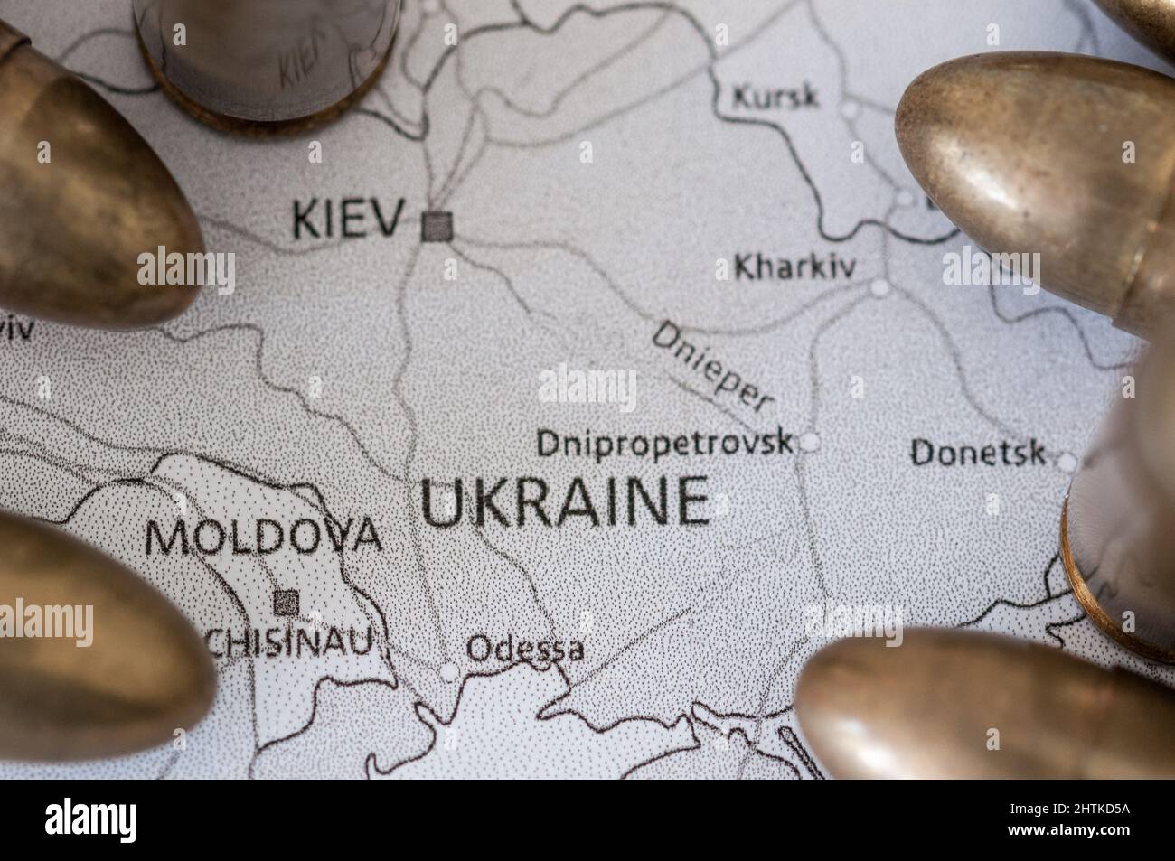 black and white geographic map of ukraine surrounded by blurred bullets Stock Photo