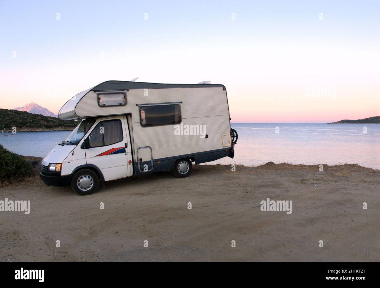 RV Camper On the Beach At Sunset Stock Photo