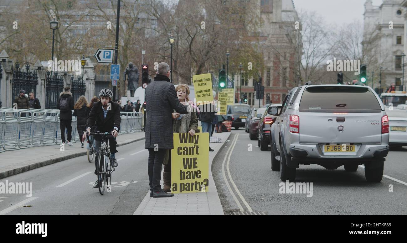 London, UK - 12 13 2021: A woman demonstrator holding a sign ‘Why can’t ...