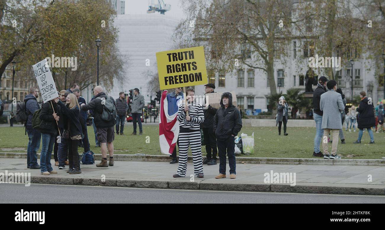 London, UK - 12 13 2021:  A woman holding a sign ‘Truth, Rights, Freedom.’ on Parliament Square, at a freedom rally anti vaccination. Stock Photo