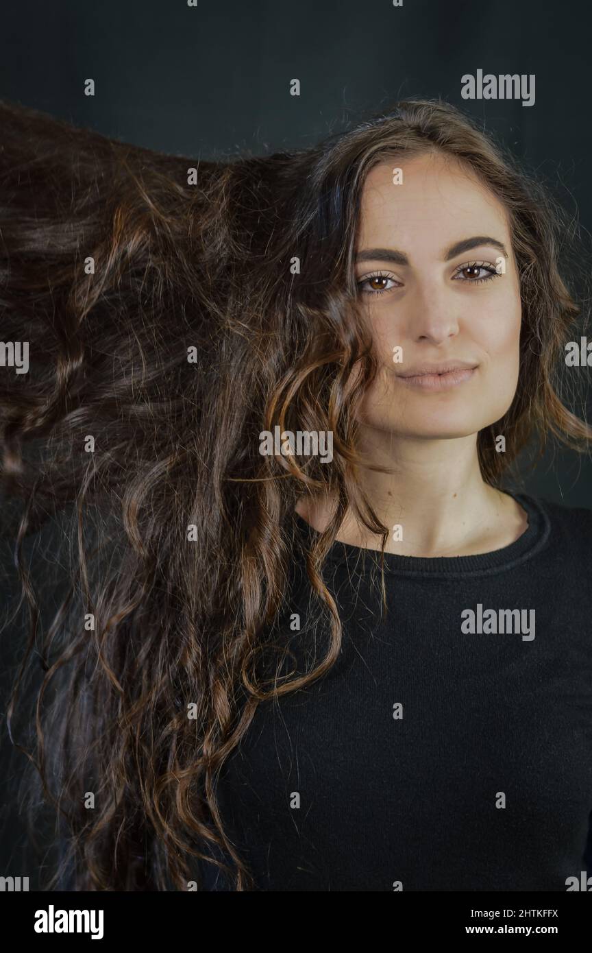 Portrait of a beautiful young Italian woman with very long brown hair ...