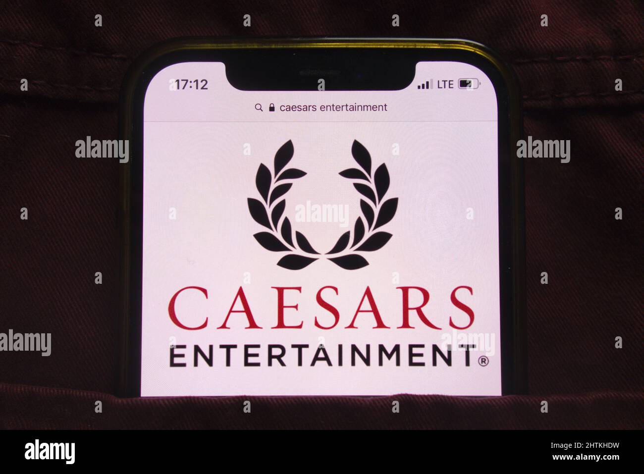 KONSKIE, POLAND - February 27, 2022: Caesars Entertainment Inc logo displayed on mobile phone hidden in jeans pocket Stock Photo