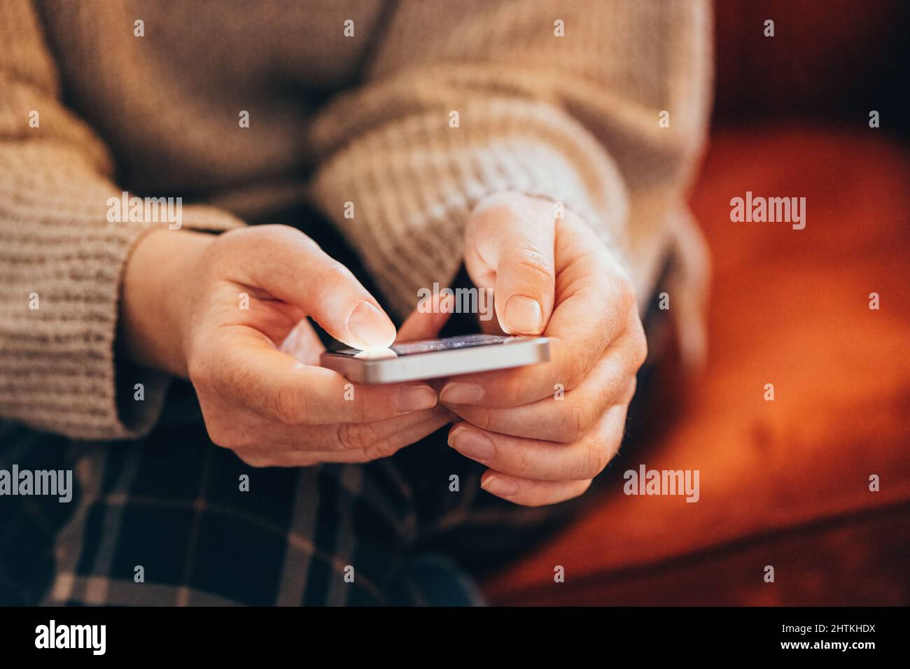 Fomo, fear of missing out on information, events or experiences makes people use their smartphones more than usual, selective focus Stock Photo