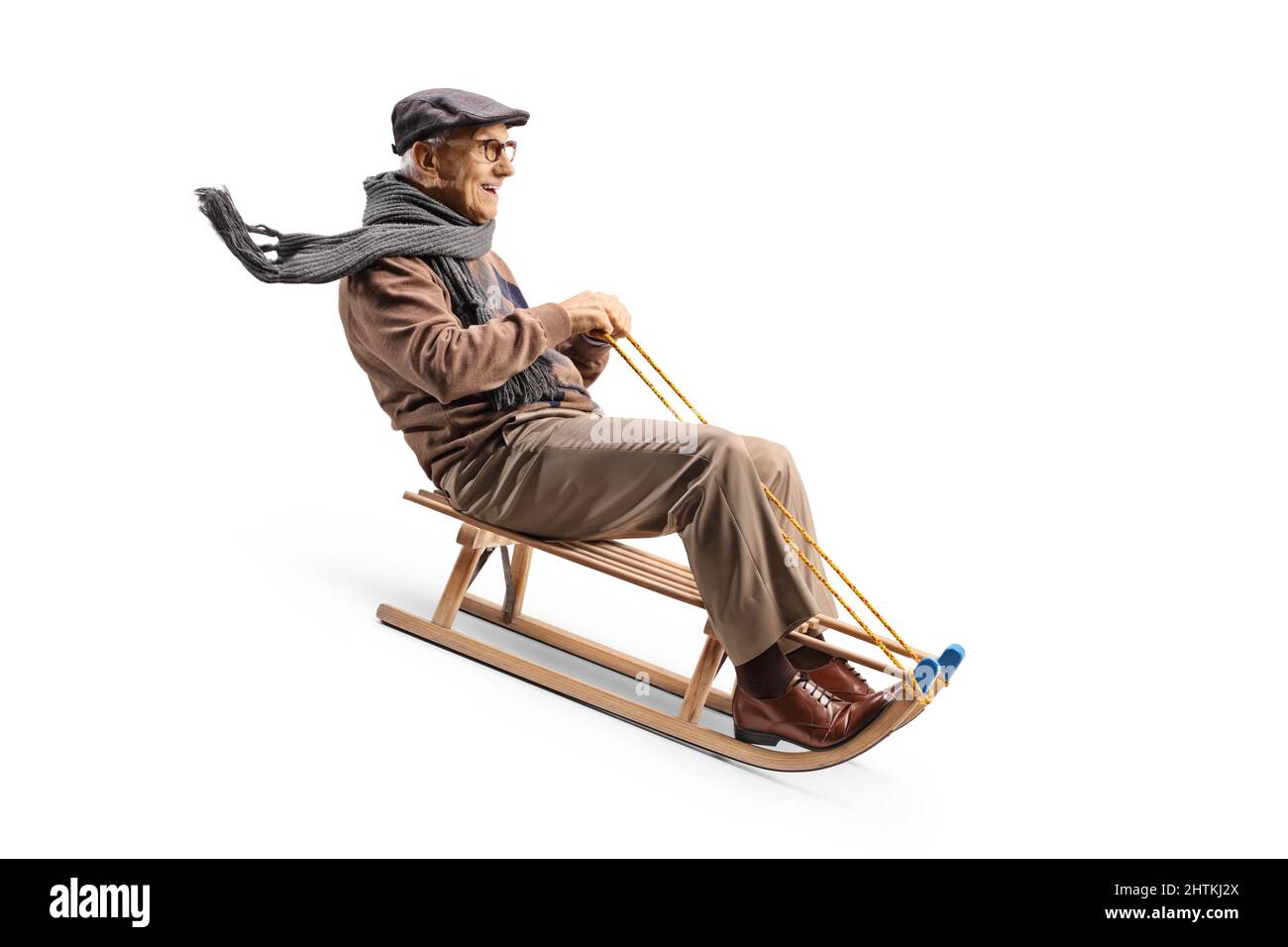 Elderly man riding on a wooden sleigh isolated on white background Stock Photo