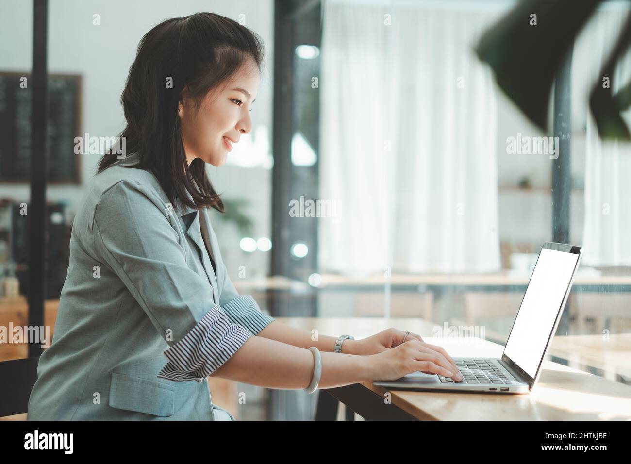 Asian Woman blogger wear blue suit talking with followers, live streaming on social media application. Freelance work from home concept. Stock Photo