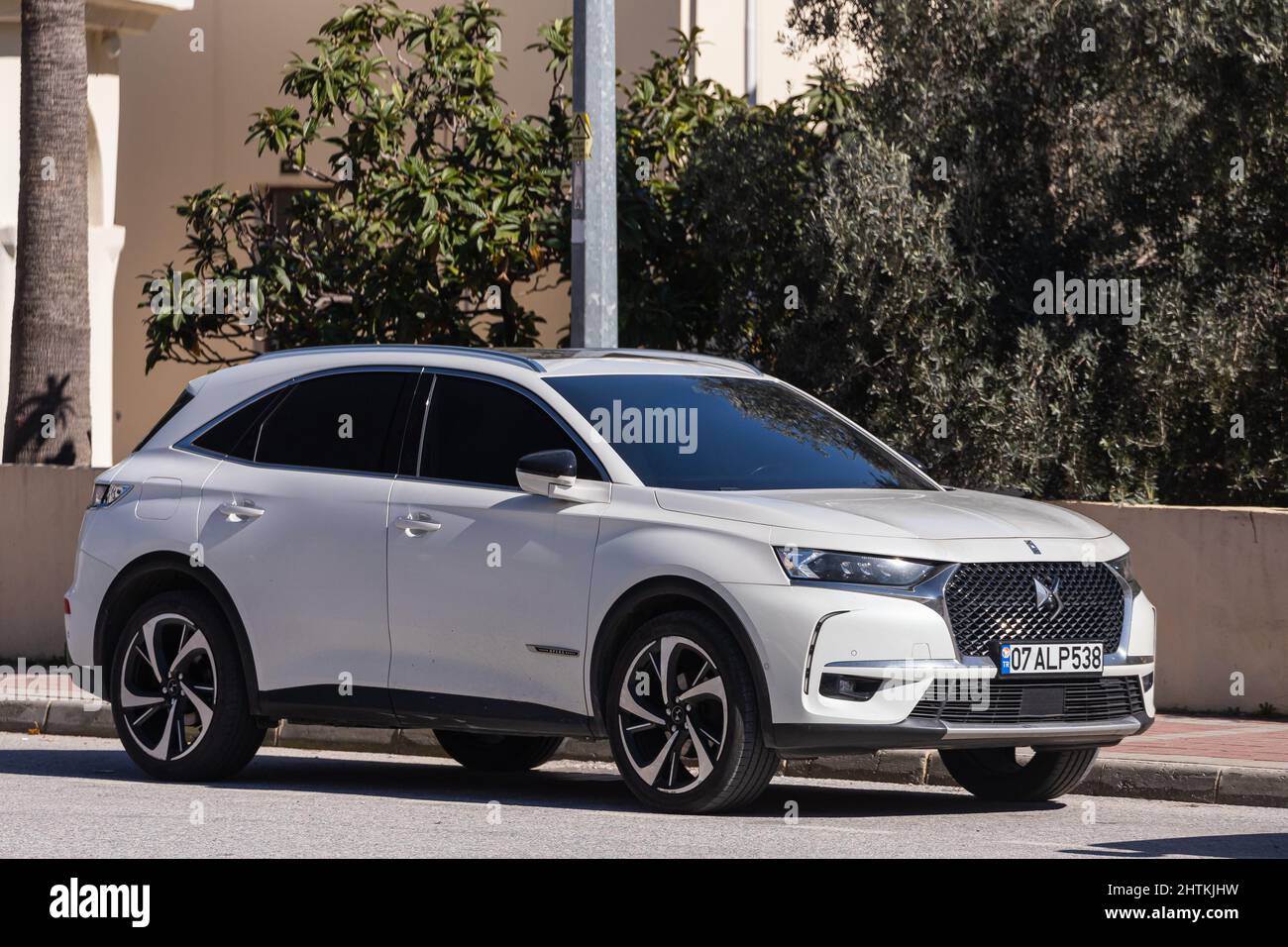 Side, Turkey – February 13 2022:   white  Citroen  DS 7 Crossback  is parked  on the street on a warm summer day against the  park Stock Photo