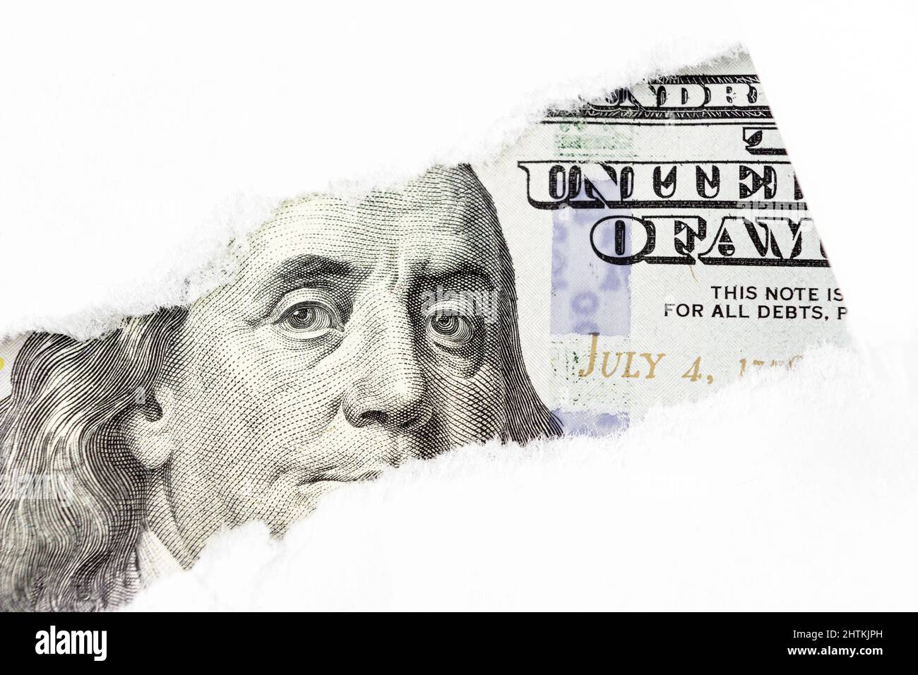 One hundred dollars bill fragment, Benjamin Franklin portrait on 100 banknote in torn paper hole. New sample money Stock Photo