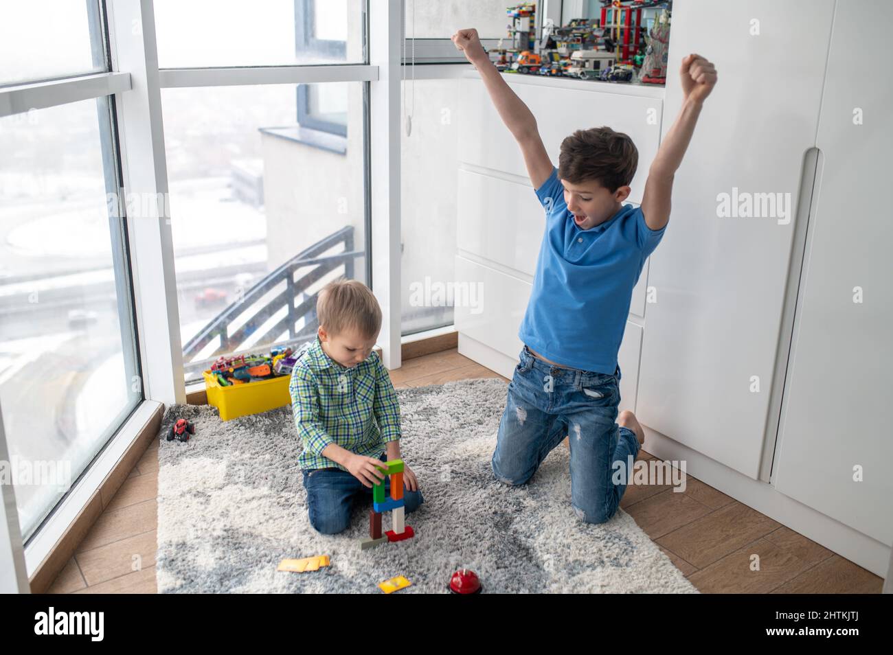 Kid encouraging his brother during the game Stock Photo