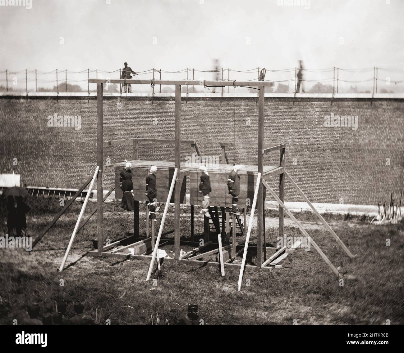 Mary Surratt, Lewis Powell, David Herold, and George Atzerodt hanging from the gallows at Fort McNair, Washington D.C., July 7, 1865.  They had been convicted of being part of the conspiracy which resulted in the assassination of President Abraham Lincoln by John Wilkes Booth on April 14, 1865. Stock Photo