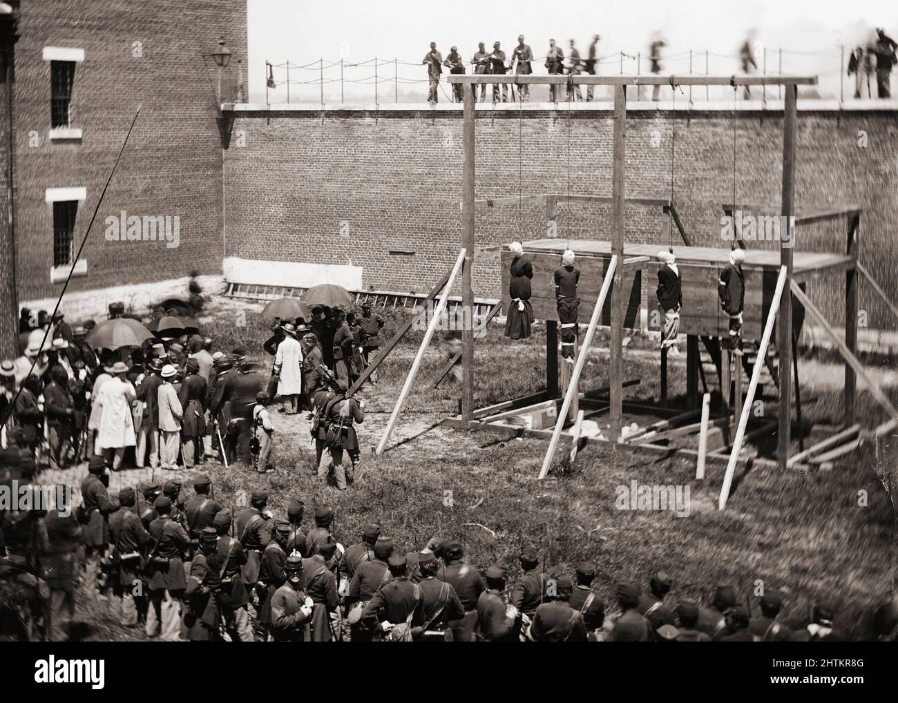 Mary Surratt, Lewis Powell, David Herold, and George Atzerodt hanging from the gallows at Fort McNair, Washington D.C., July 7, 1865.  They had been convicted of being part of the conspiracy which resulted in the assassination of President Abraham Lincoln by John Wilkes Booth on April 14, 1865. Stock Photo