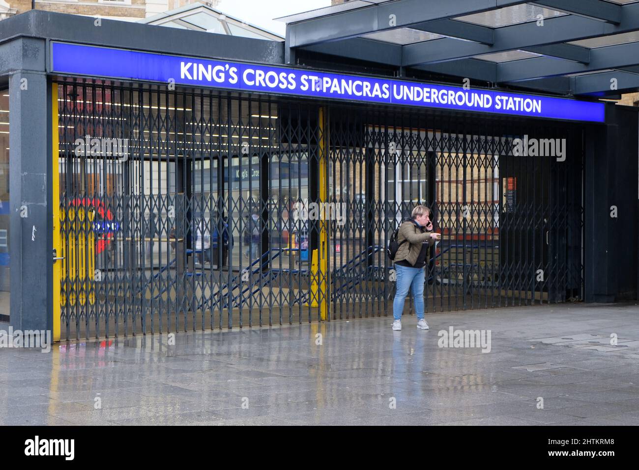 London, UK, 1st Mar, 2022. A woman stands outside a shuttered King's Cross St. Pancras Undergound Station as visitors and commuters found alternative ways to complete their journey this afternoon, via bus, taxi or cycling, amid a Tube strike affecting all services. The strike called by the RMT Union over threats of 600 job losses and pension cuts saw 10,000 staff walk out. Credit: Eleventh Hour Photography/Alamy Live News Stock Photo
