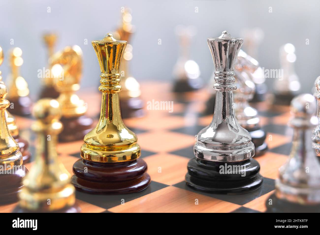 Focus on two Queens next to each other among other chess pieces. The concept of confrontation, the struggle of leaders, the strategy of winning in a c Stock Photo