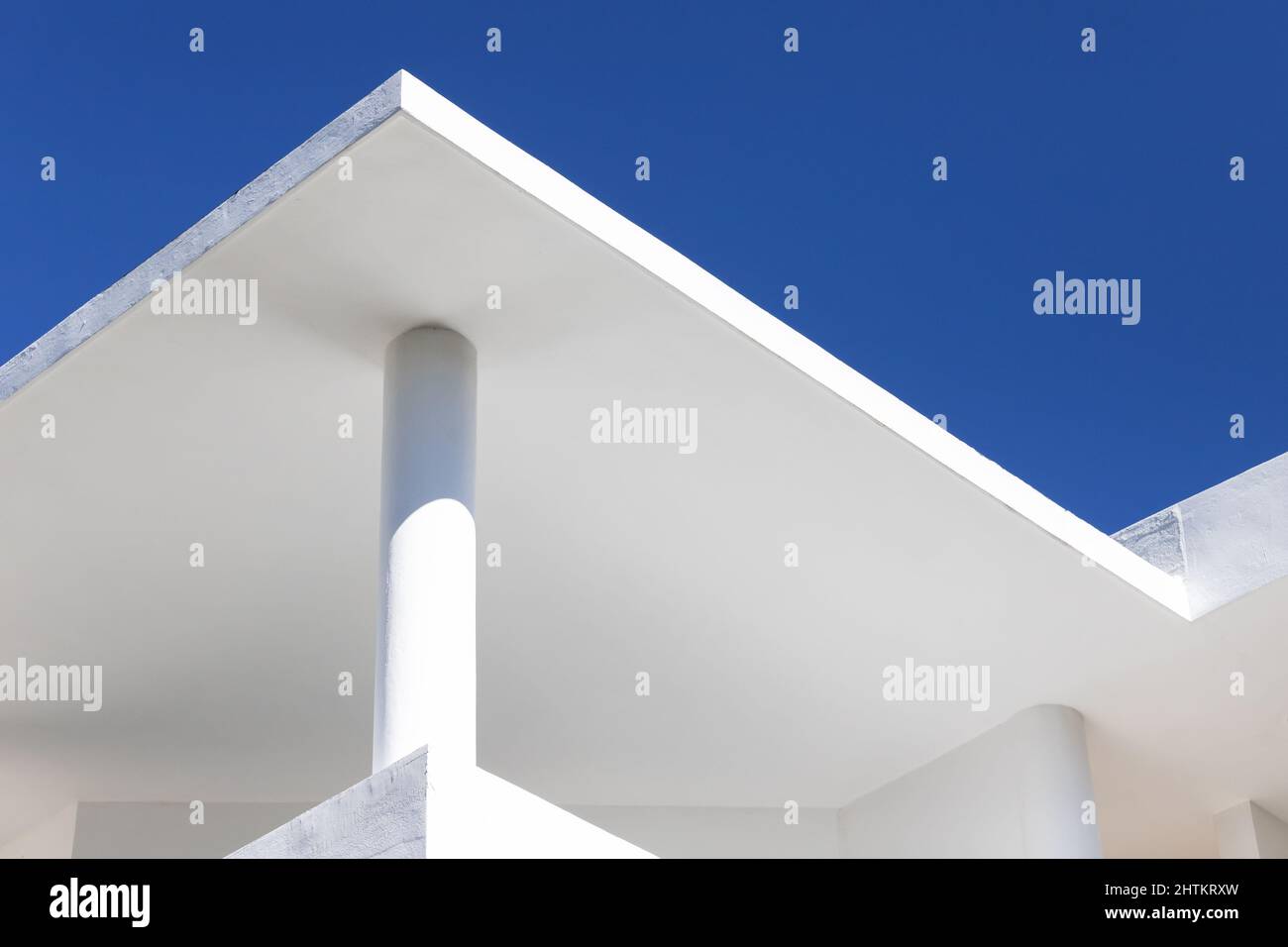 Abstract architecture background with white concrete house exterior details under clear blue sky Stock Photo