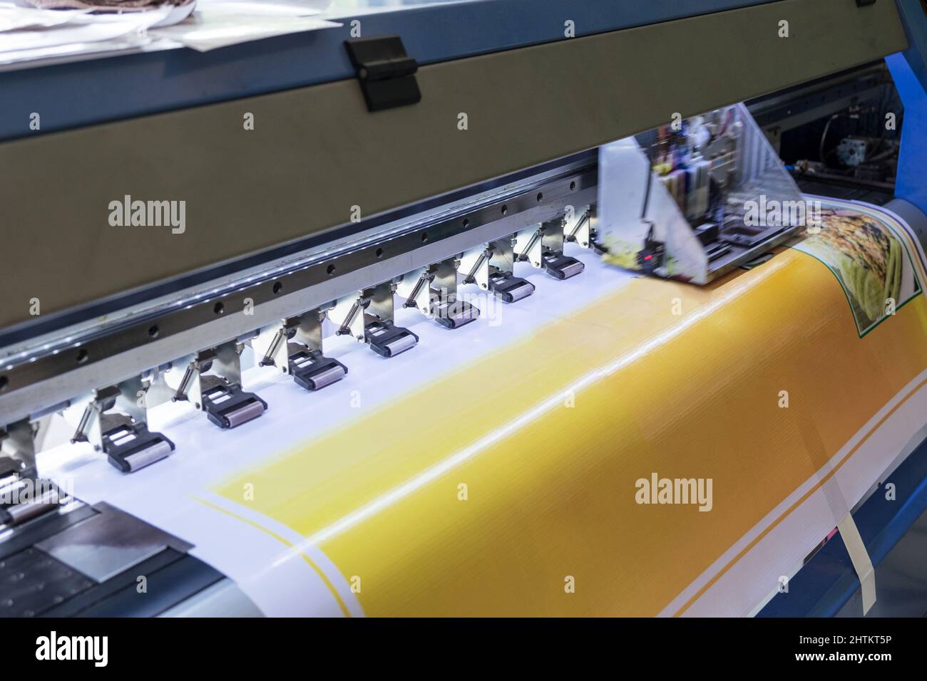 Large format inkjet printer machine working printout yellow color on
