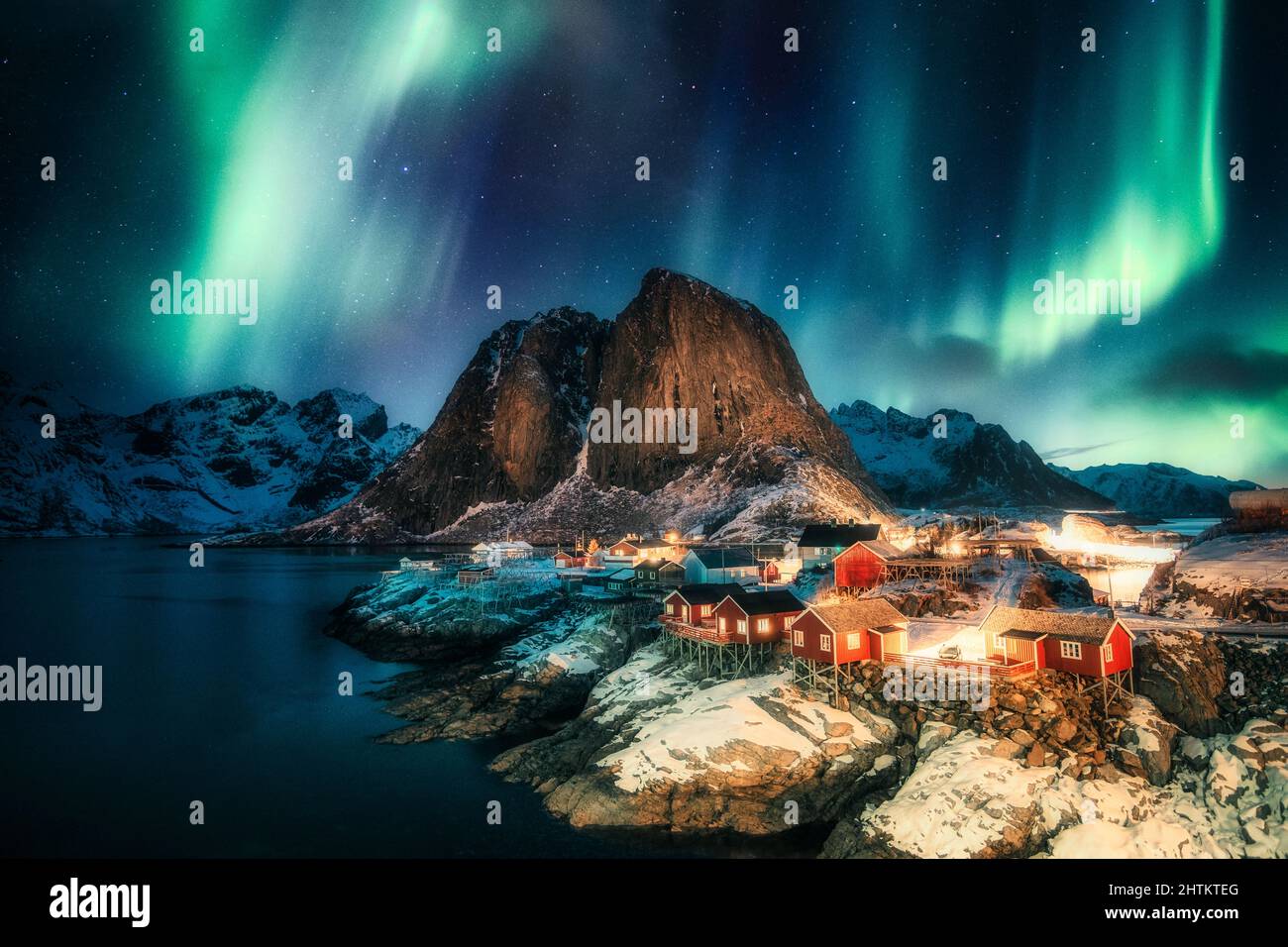 Aurora borealis, Northern lights over mountain with fishing village on ...
