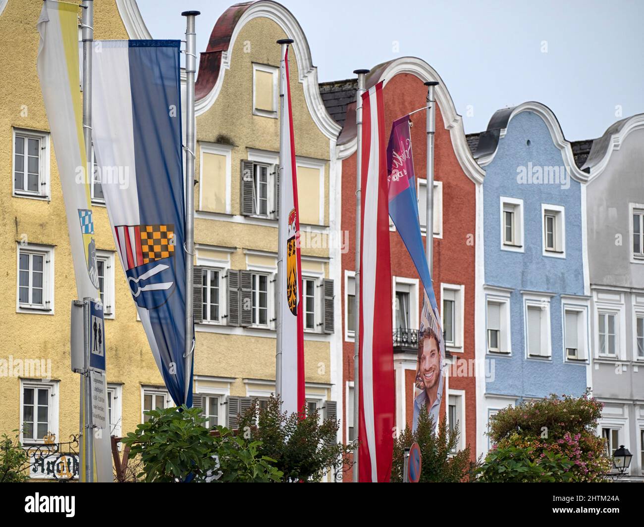 SCHARDING, AUSTRIA - JULY 12, 2019:  Banner signs outside the colourful Baroque town houses of Oberer Stadtplatz Stock Photo