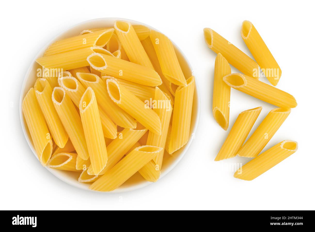 Raw italian penne rigate pasta in ceramic bowl isolated on white background with clipping path and full depth of field. Top view. Flat lay Stock Photo