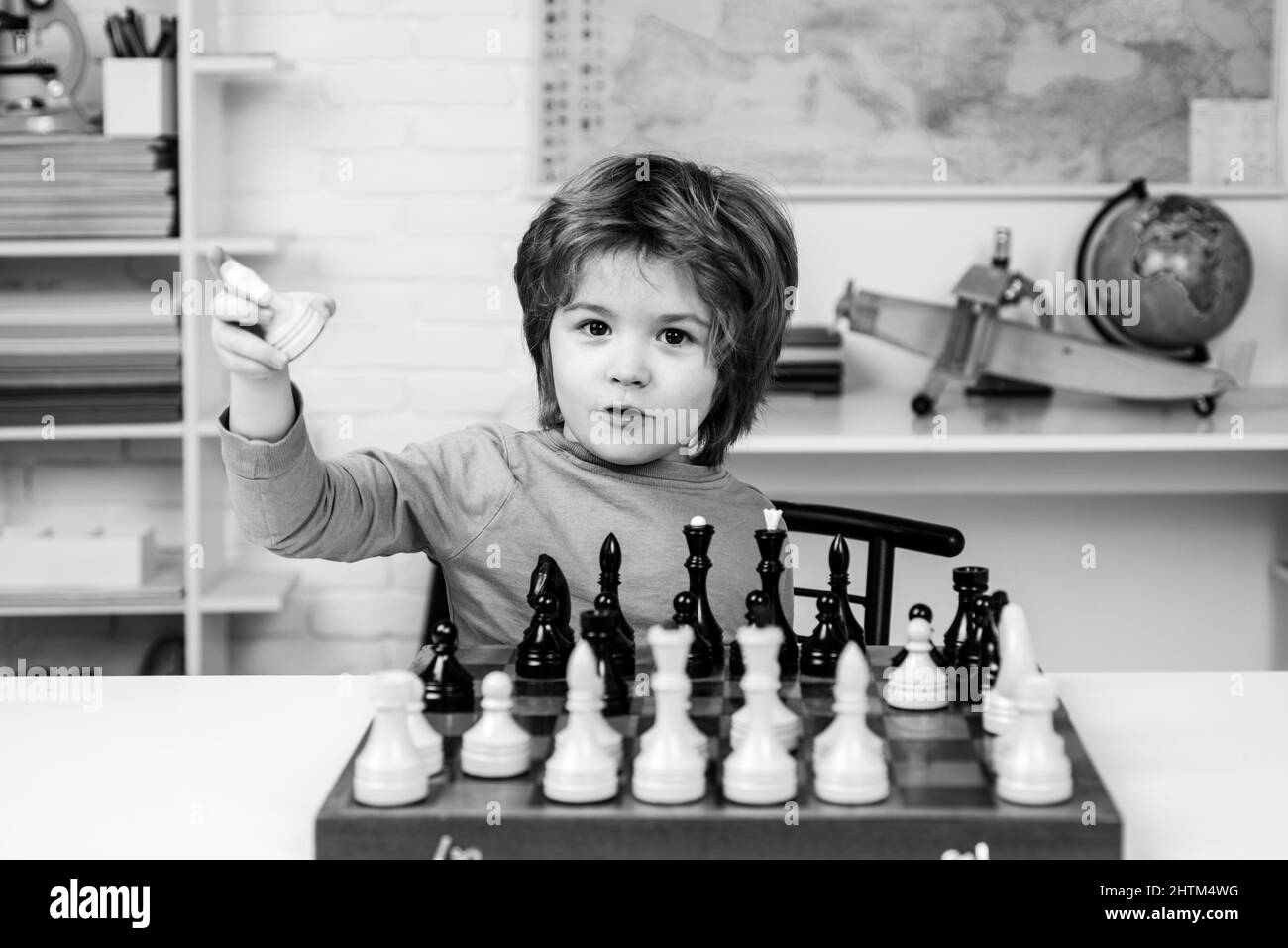 Little boy playing chess. Kids educational games, early development. Stock Photo