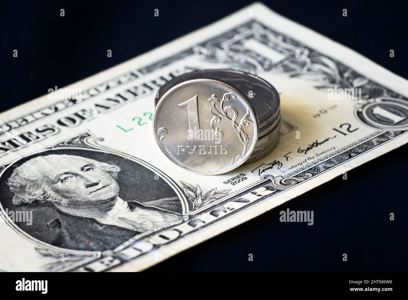 Russian ruble coin and one US dollar bill, ruble money is under pressure from geopolitics. Concept of currency exchange rate, ruble devaluation, infla Stock Photo