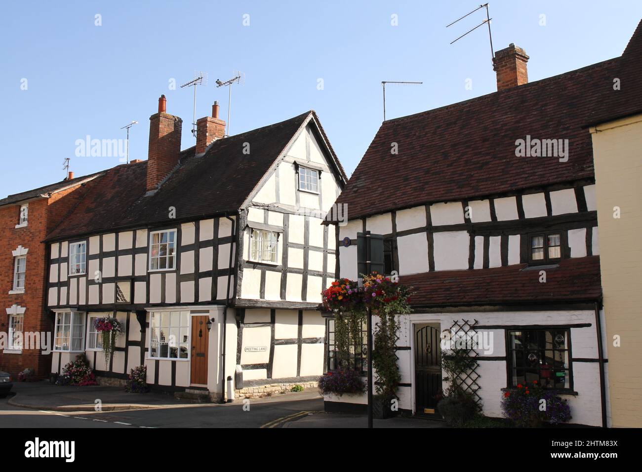 Black and white Half Timbered Houses in Alcester, Warwickshire, UK. Shakespeare's country, with blue sky in the summer. Stock Photo