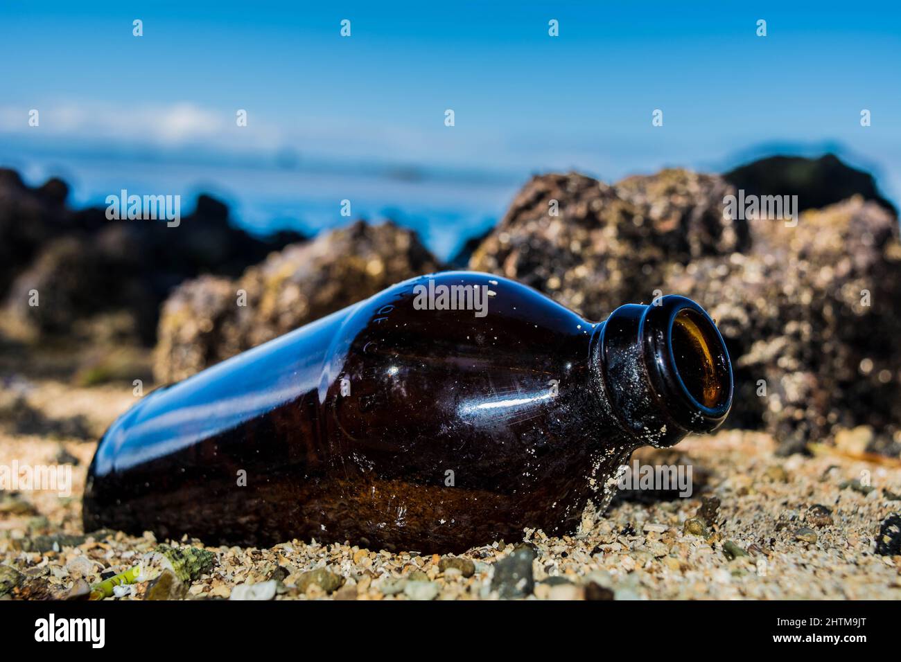 Empty bottle washed up ashore in Fiji Stock Photo