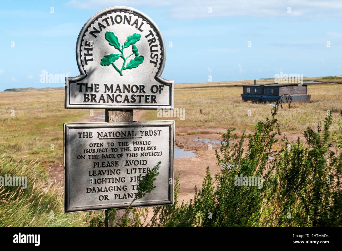 National Trust sign for The Manor of Brancaster at Brancaster Staithe on the North Norfolk Coast. Stock Photo