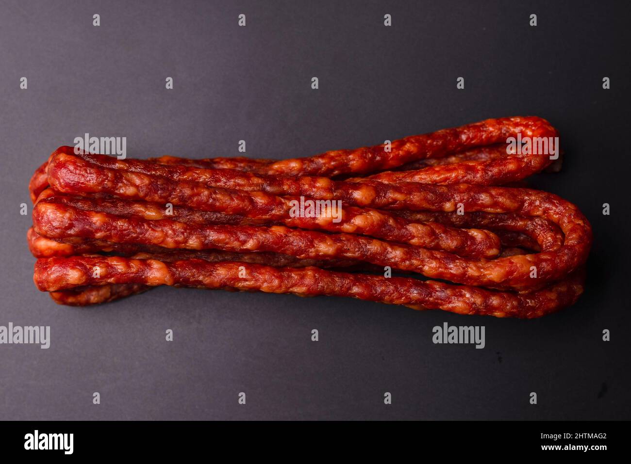 Cabanossi, dry sausage isolated on a black background Stock Photo - Alamy