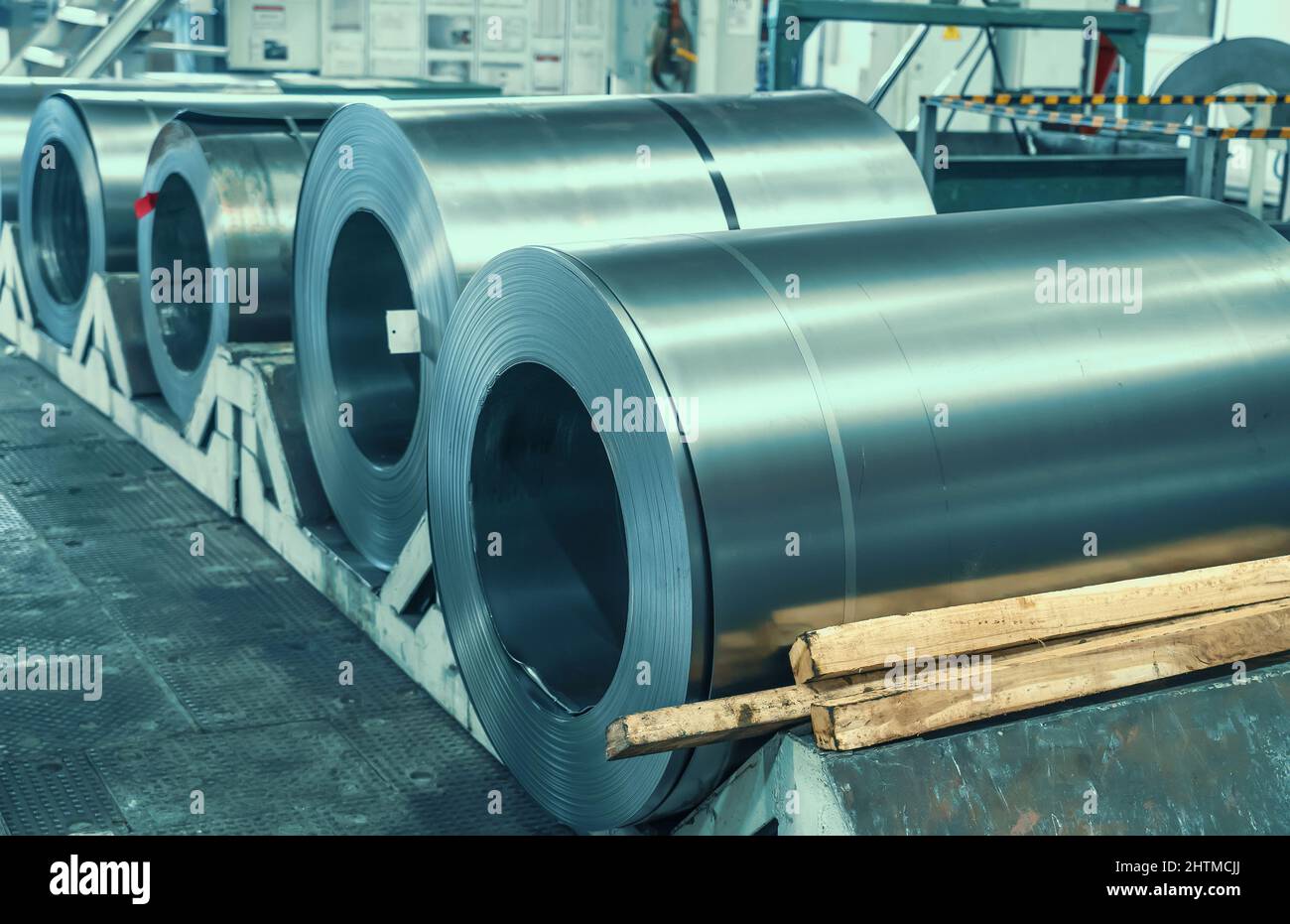Rolls of sheet steel in factory. Galvanized steel coils for metalwork. Stock Photo