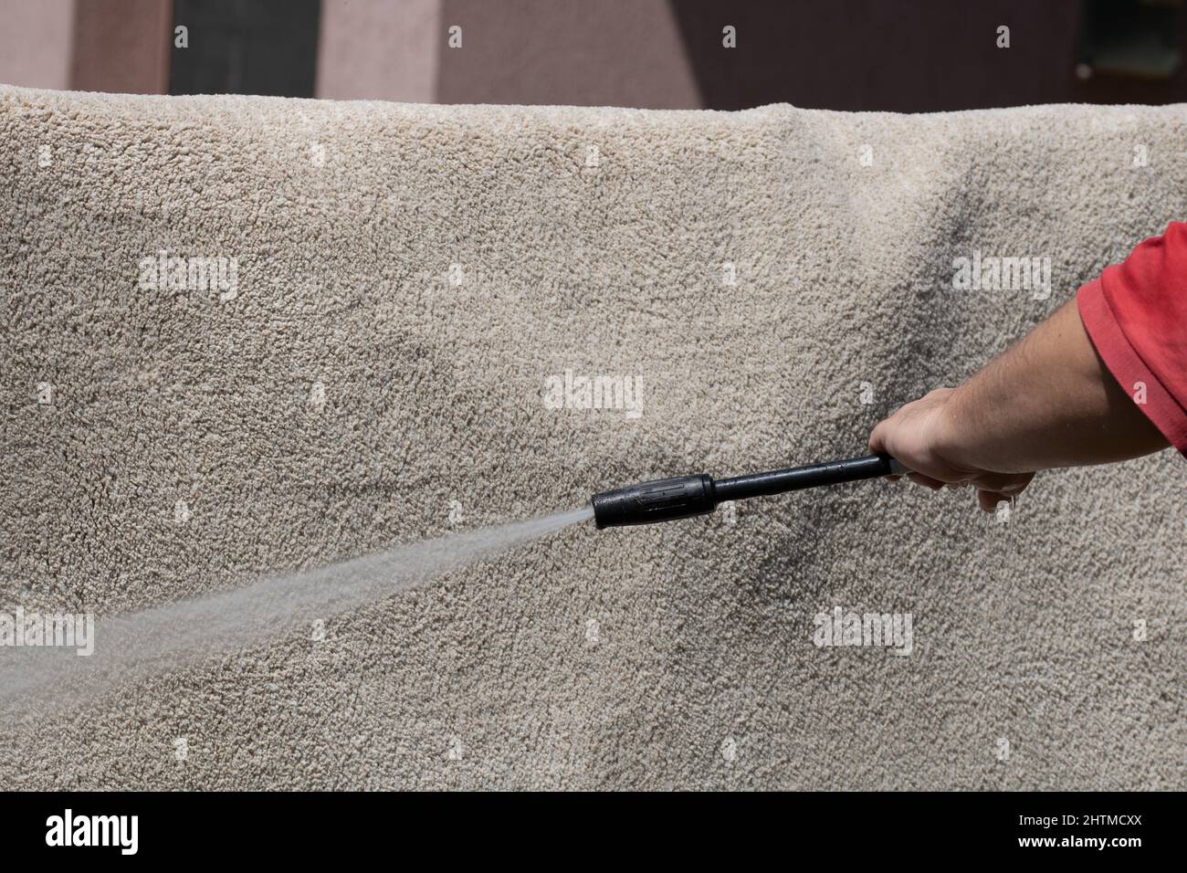 Washing carpets with high pressure washer. Cleaning the carpet with a