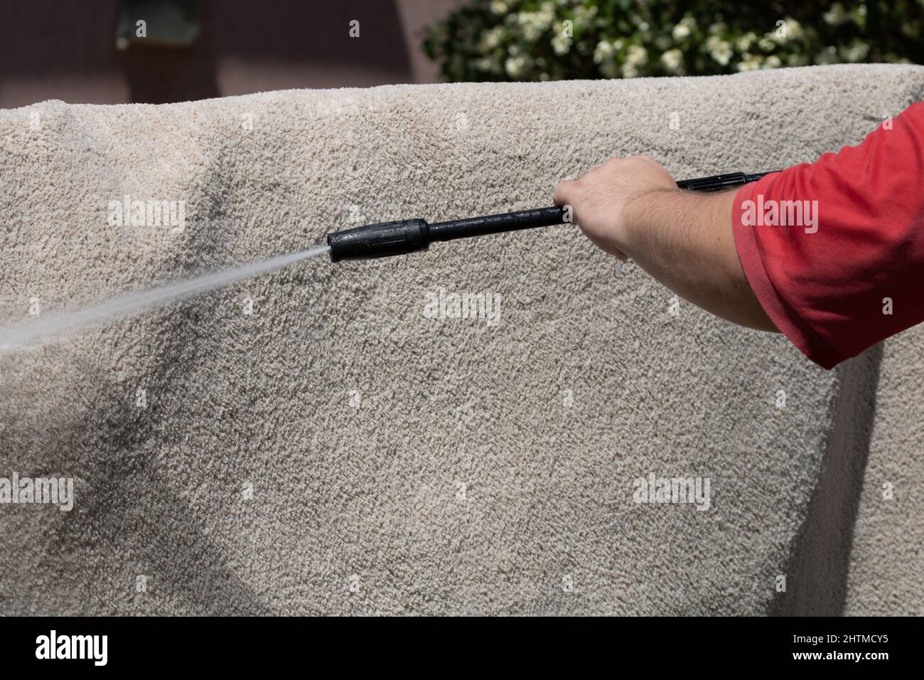 Washing carpets with high pressure washer. Cleaning the carpet with a