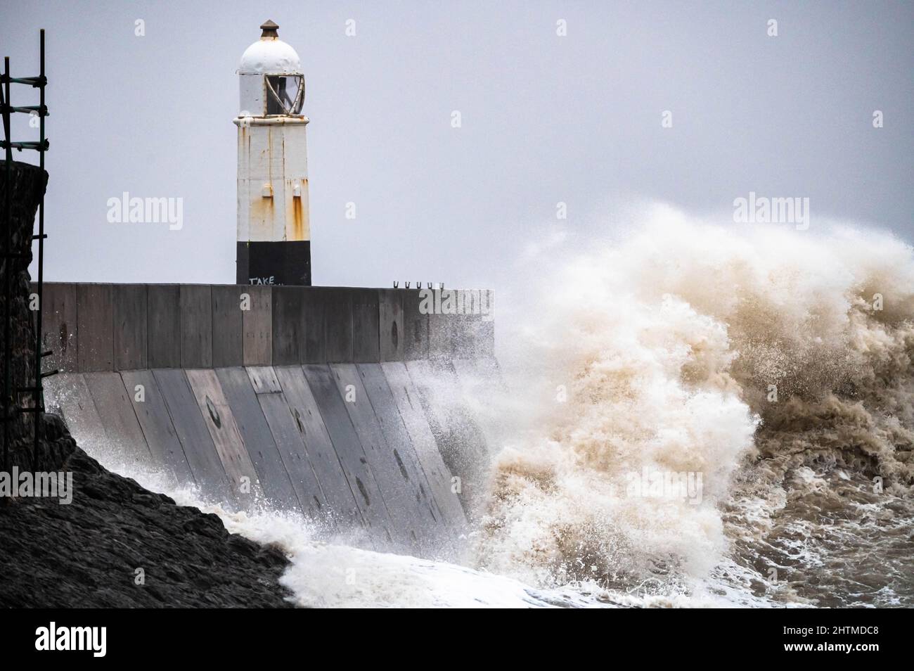 Huge ocean waves crashing into a sea wall and lighthouse Porthcawl ...