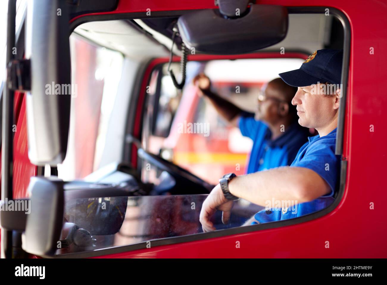 Waiting on the next call. Shot of firemen sitting in a truck. Stock Photo