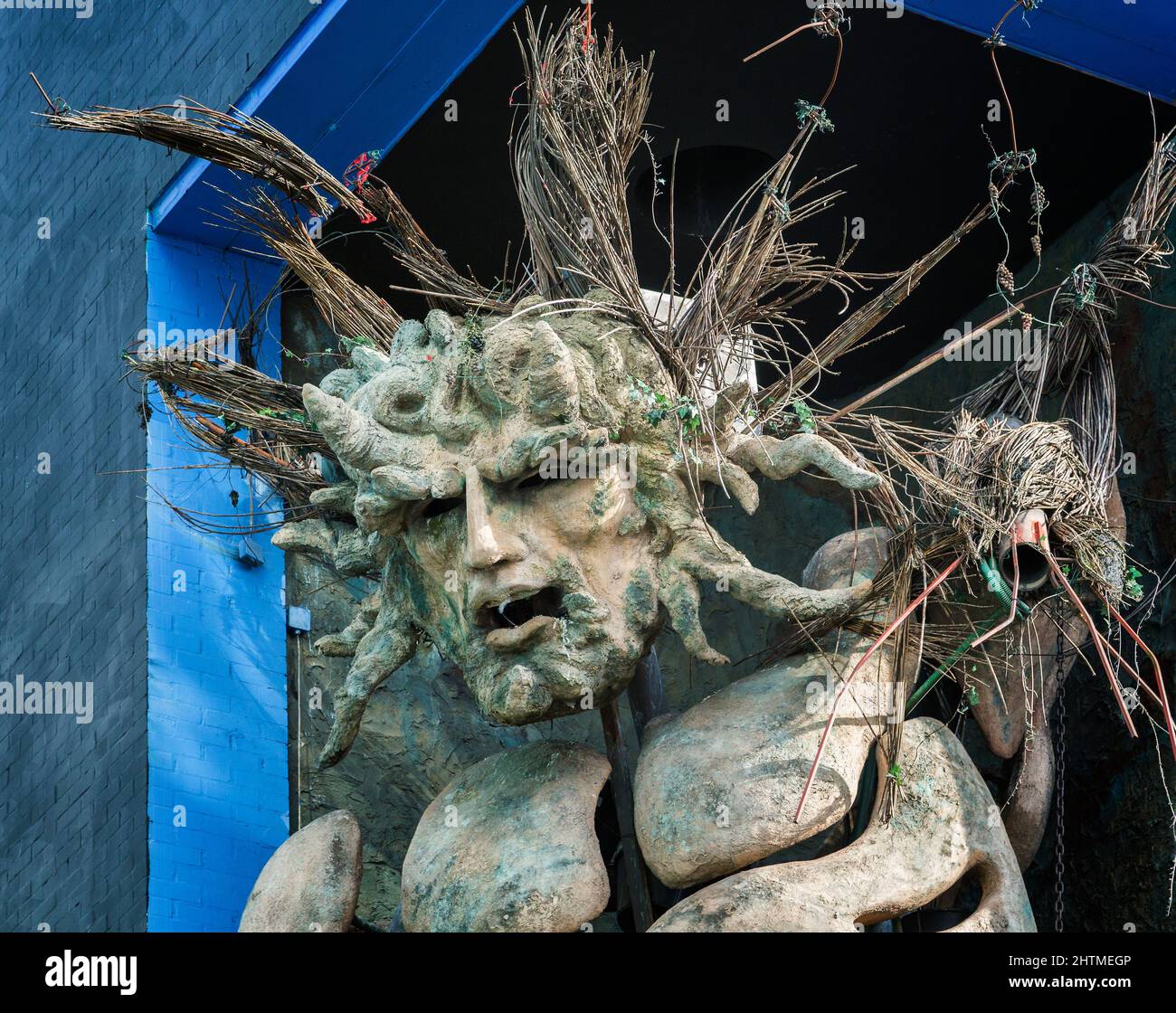 Head shot of the Green man sculpture standing tall at the Custard