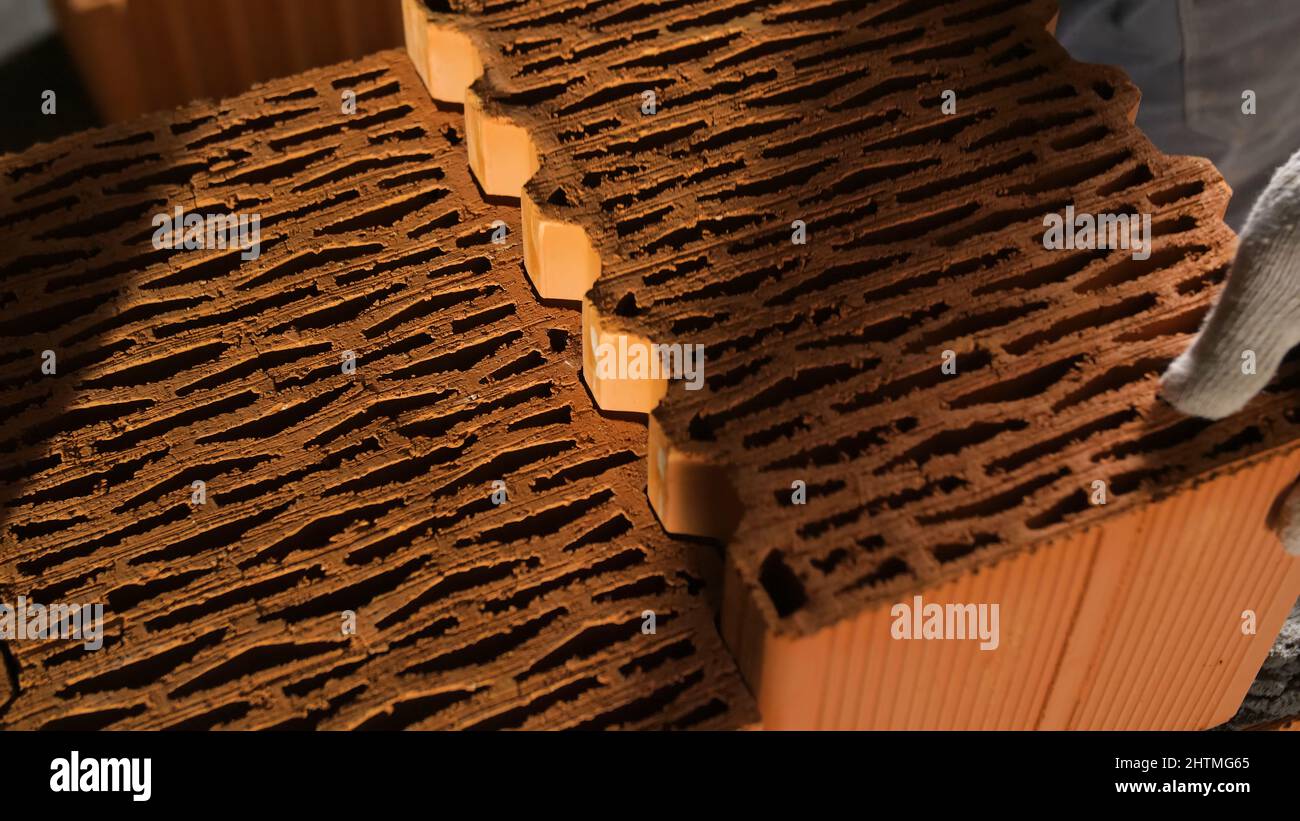 Bricklayer tapping down a block wall. Stock footage. Construction